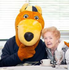 UA graduate Phyllis Berry sits with Zippy